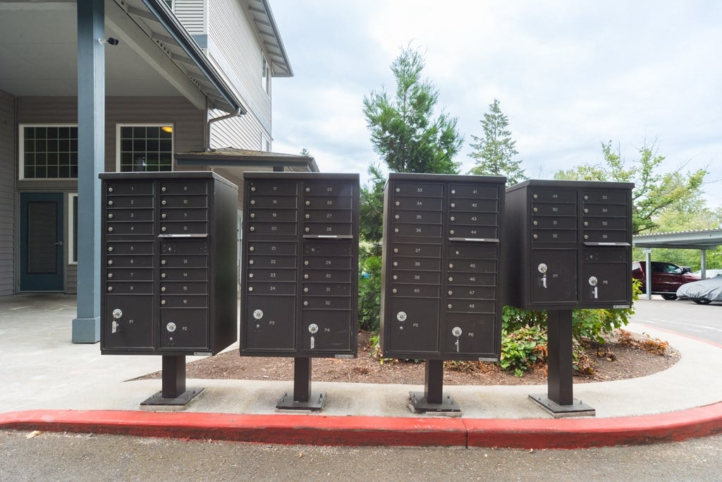 a row of mailboxes in front of a house