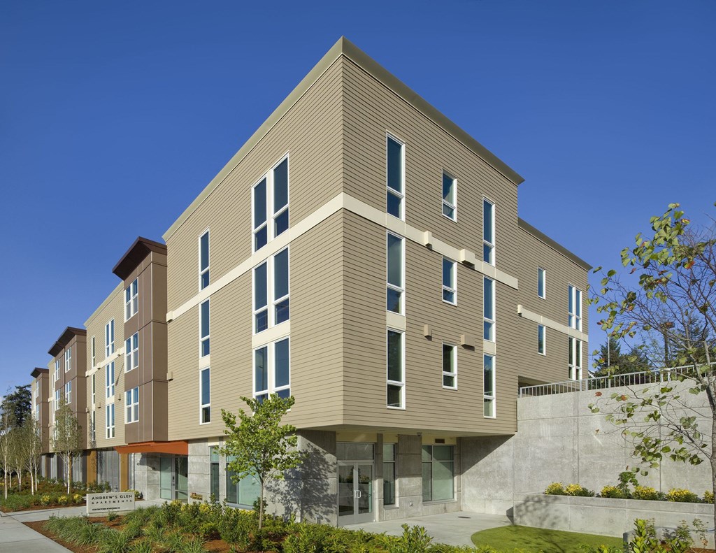 A modern building with a mix of beige and brown panels.
