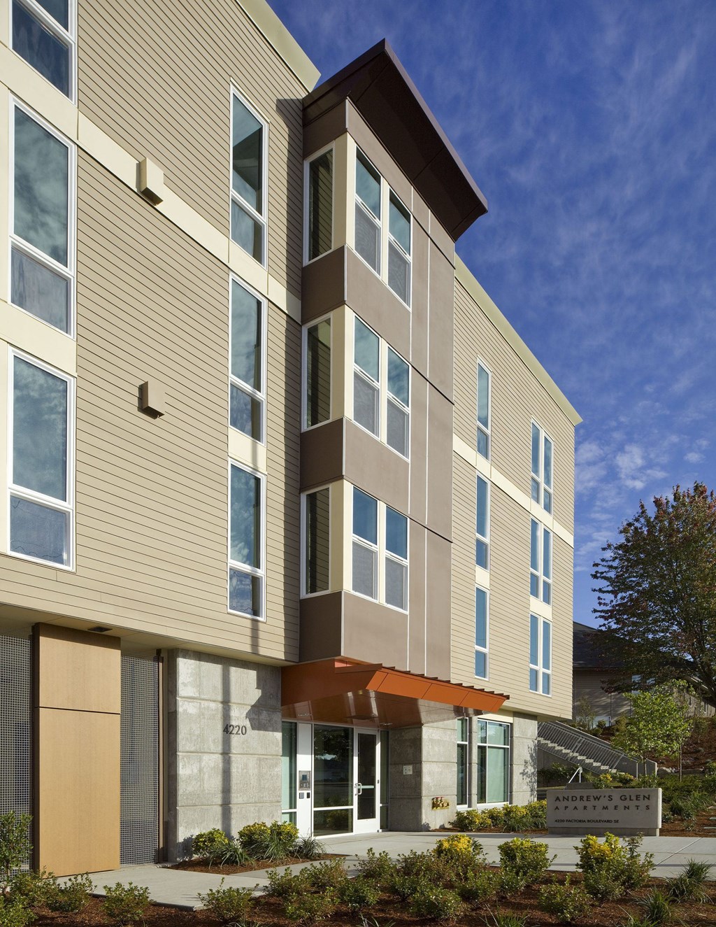 A modern building with a combination of beige and brown panels.