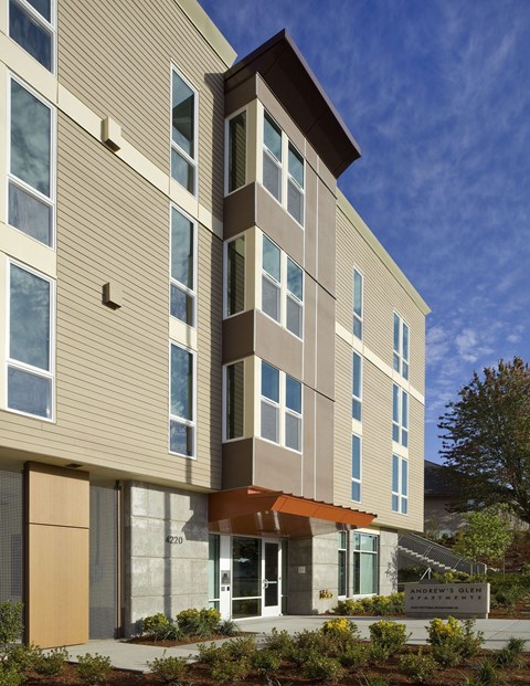 A modern building with a combination of beige and brown panels.