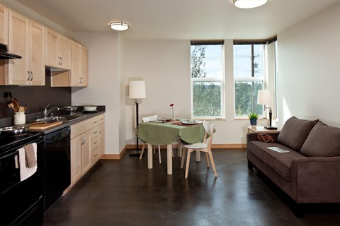 A kitchen with a table and chairs in the middle of the room.