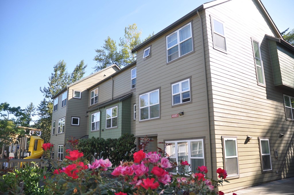 A building with a green lawn in front of it.