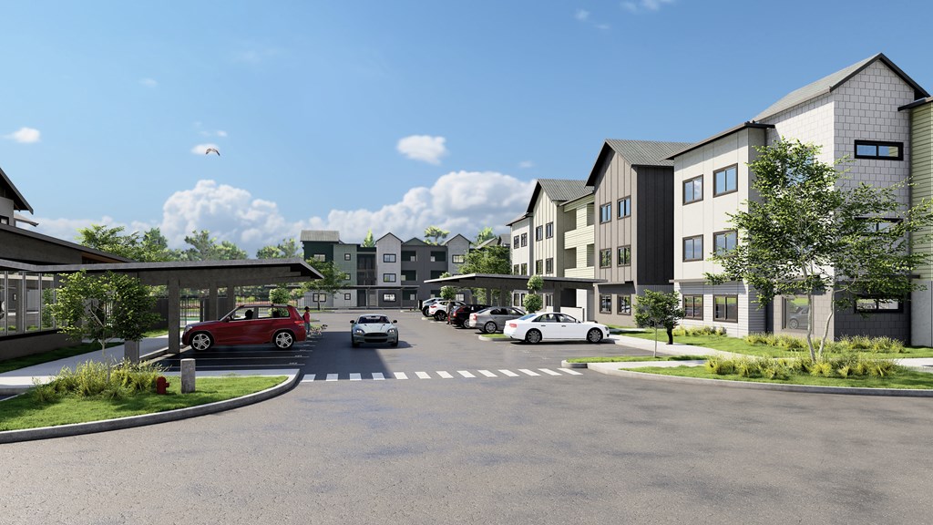 A street view of a residential area with cars and houses.