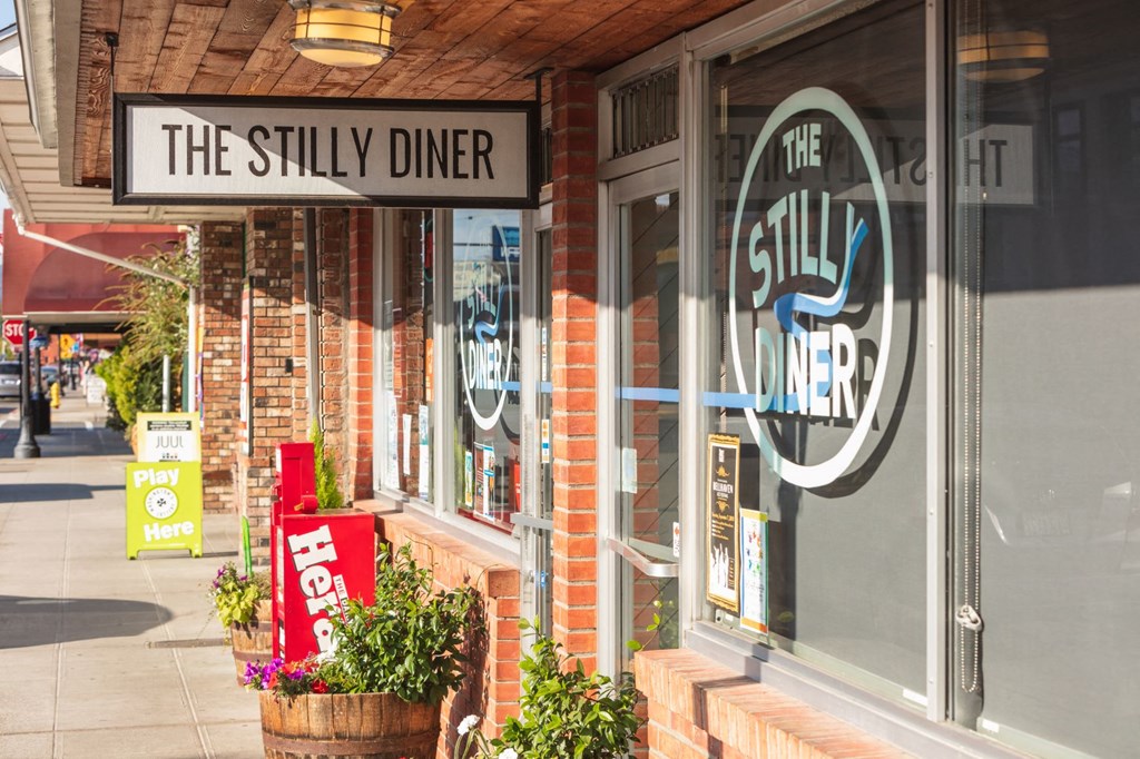 the still diner sign in front of a restaurant on the sidewalk