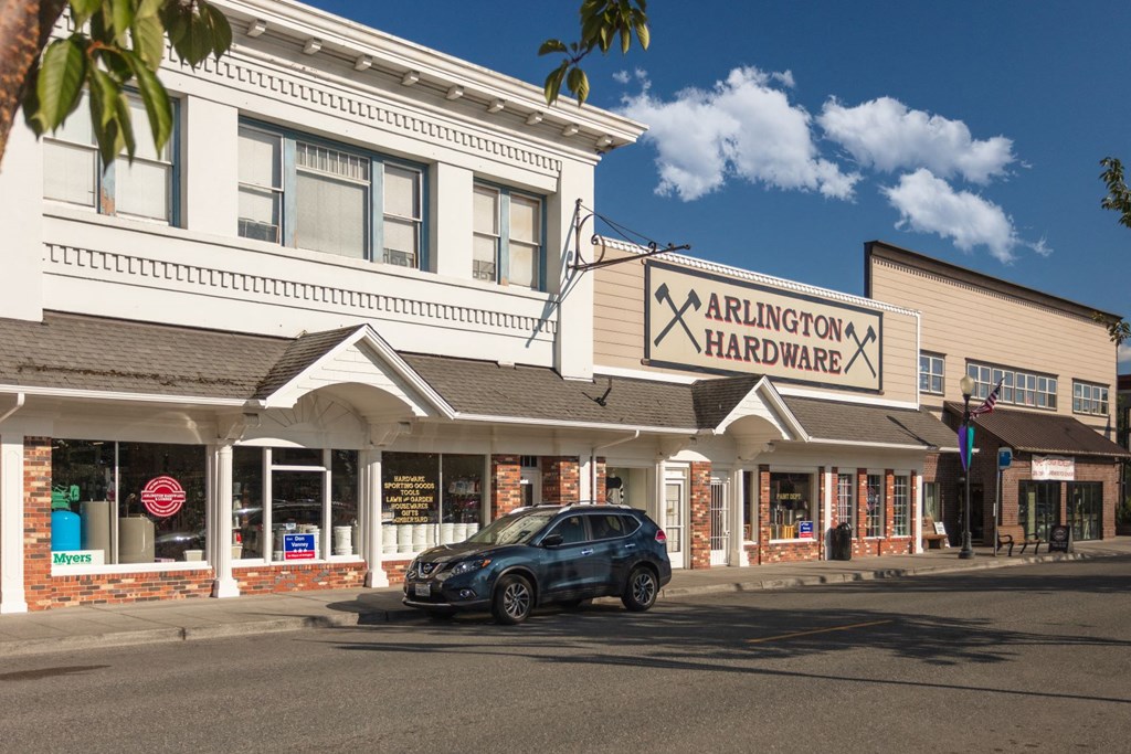a car parked in front of a store on the side of a street