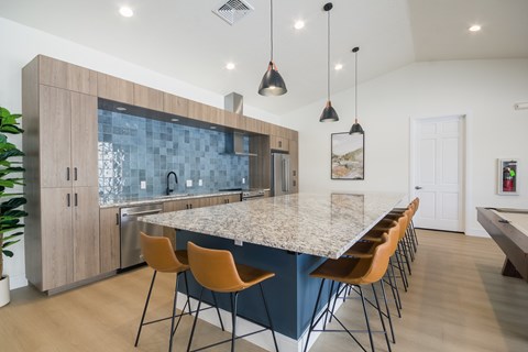 A kitchen with a blue backsplash and wooden cabinets.