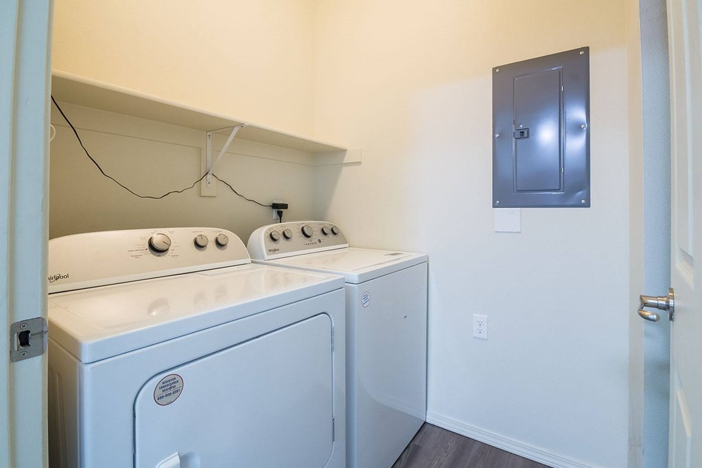 A small laundry room with a washer and dryer.