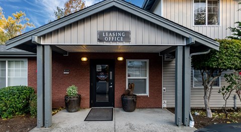 The front of a building with a sign that says Leasing Office.