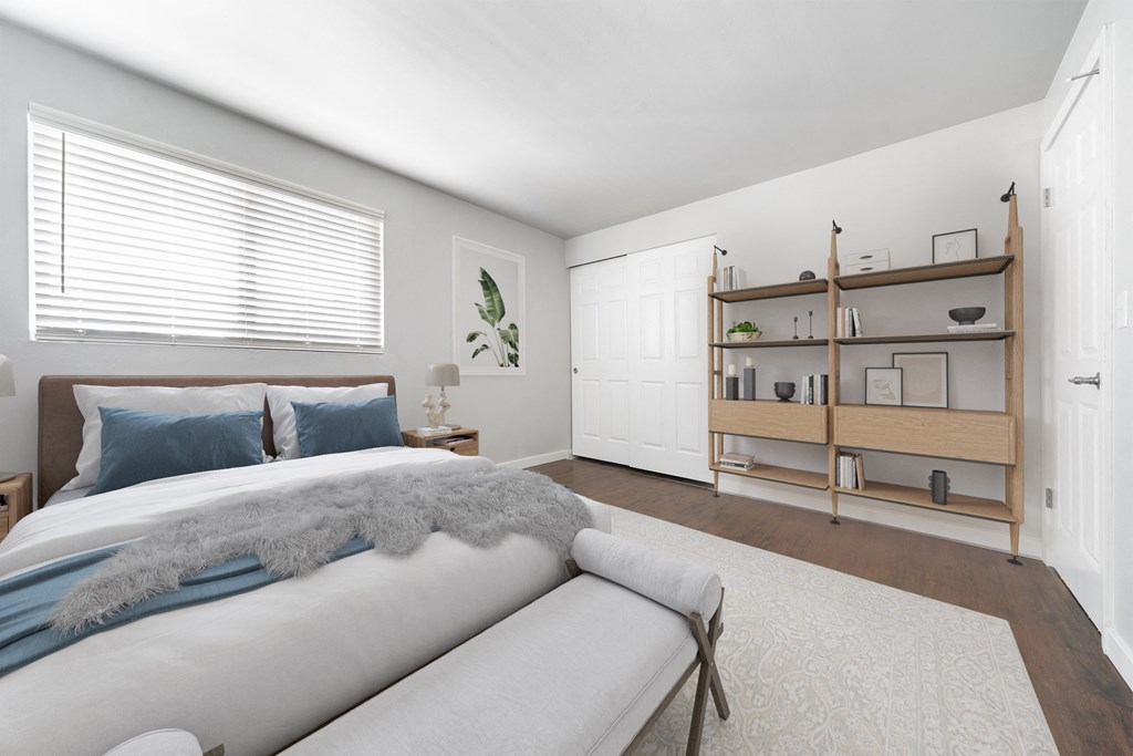 a bedroom with a large bed and a couch