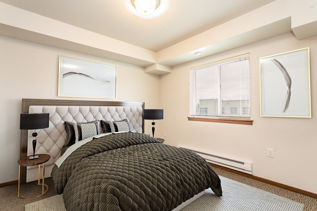 a bedroom with a bed and two windows