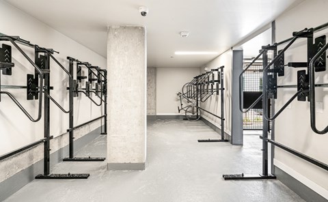 A gym with a row of exercise machines.
