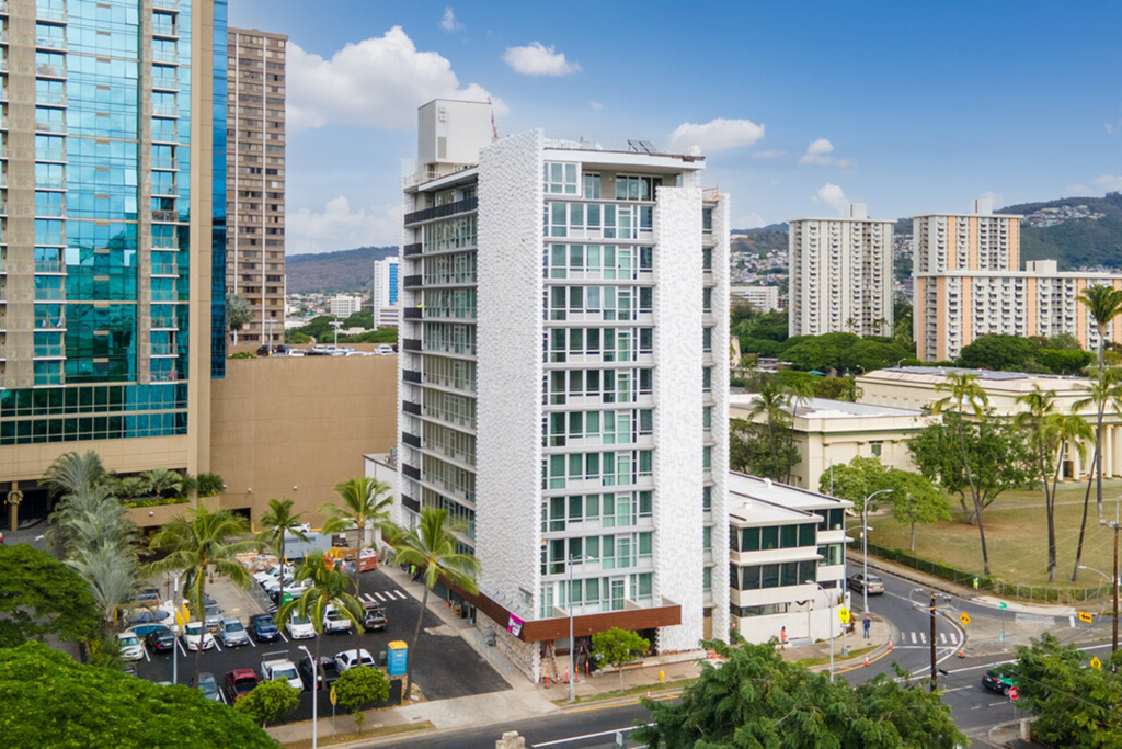an aerial view of a building in a city with tall buildings