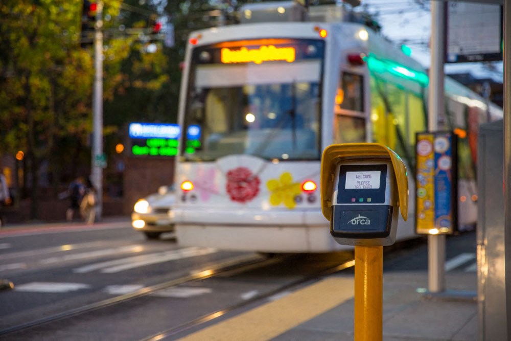 a bus driving down a city street next to a parking meter