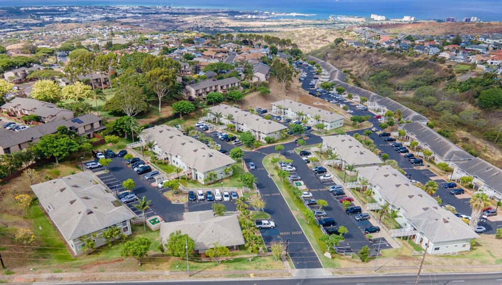an aerial view of a neighborhood of houses with cars parked