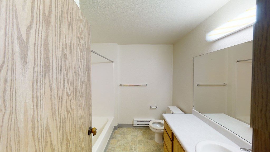 an empty bathroom with a toilet and a sink