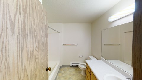 an empty bathroom with a toilet and a sink
