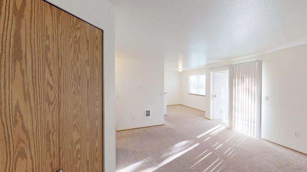 the living room and dining room of an apartment