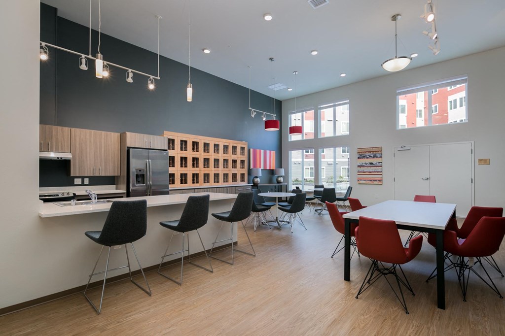 a dining room with a kitchen and a table and chairs