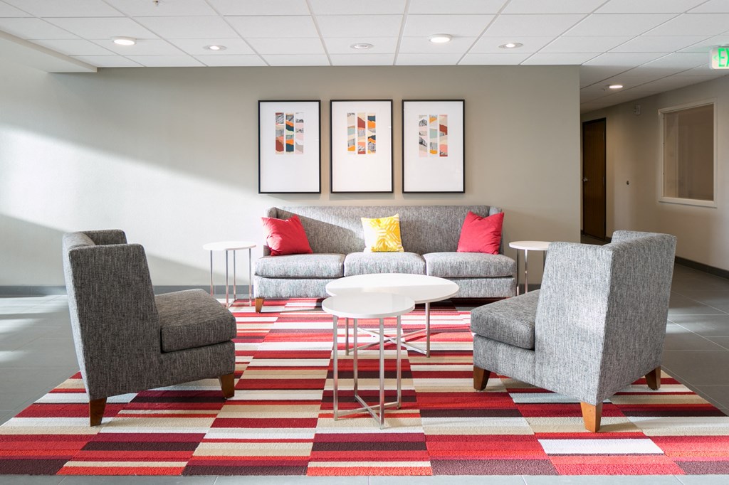 a living room with couches chairs and a rug
