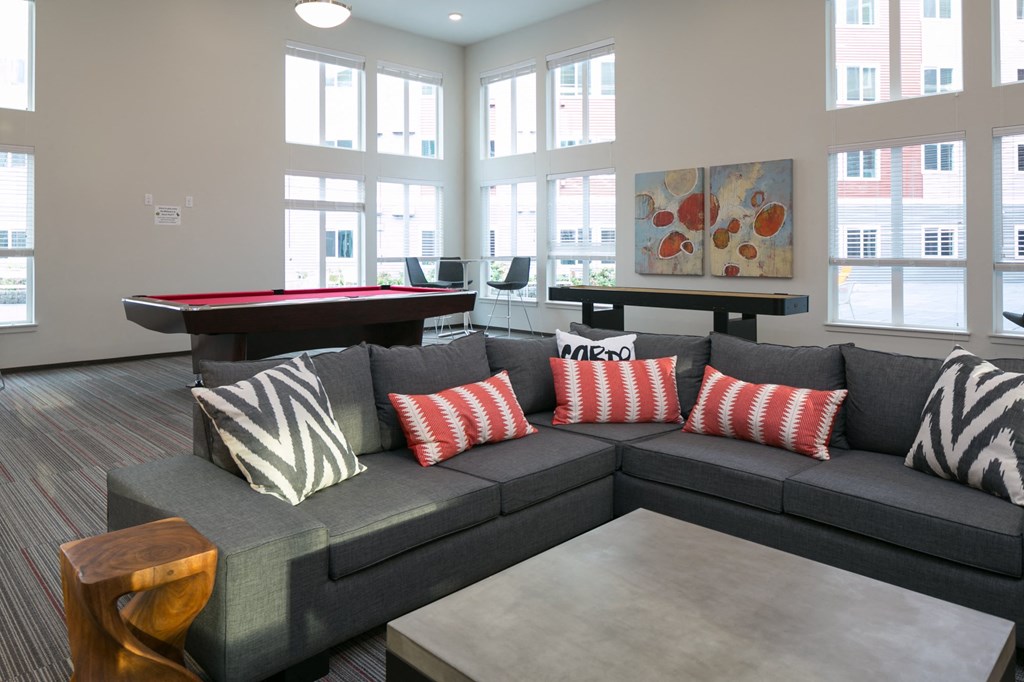 a living room with a couch and a pool table