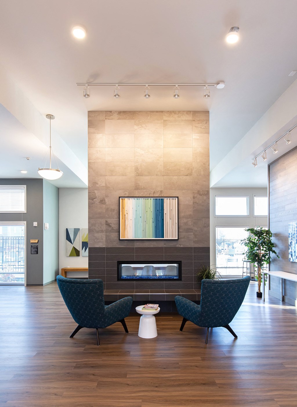 a living room with two chairs and a fireplace