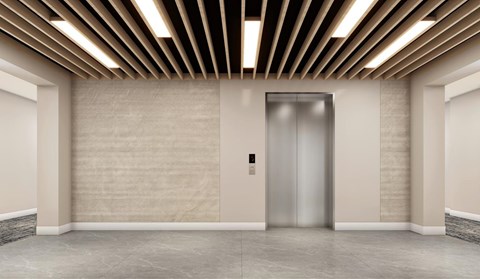 A modern elevator in a building with a metallic finish.