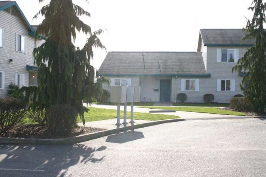 a white house with a street sign in front of it