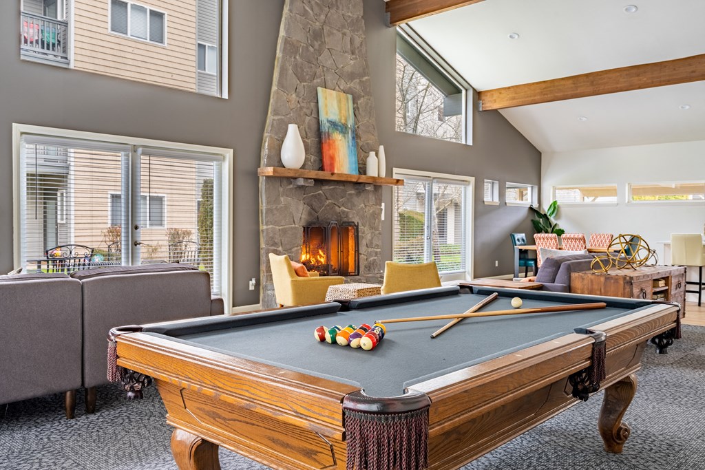 a pool table in a living room with a fireplace