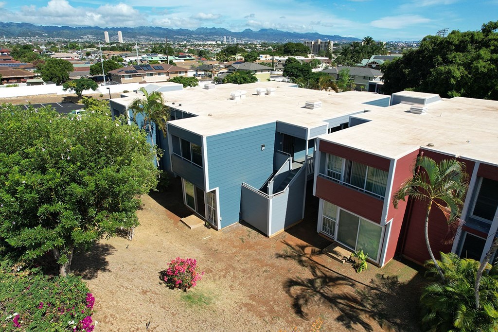 Apartment complex with a view of the city in the background.