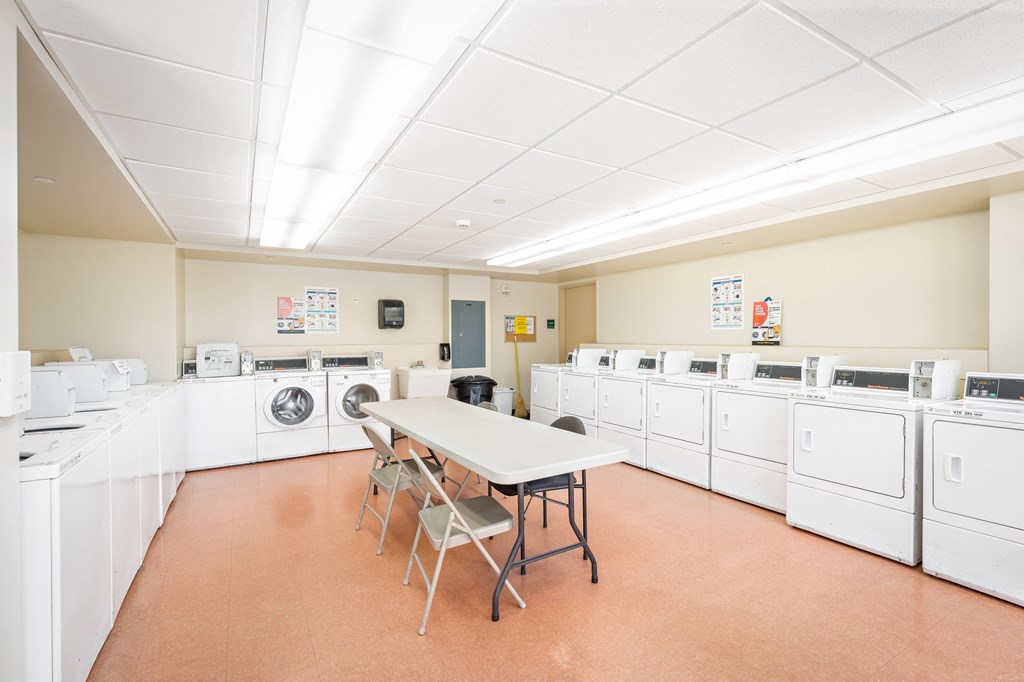 a laundry room with washers and dryers
