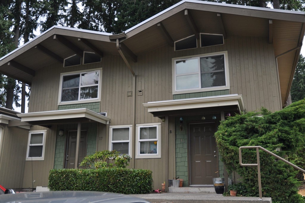 A house with a grey exterior and a brown door.