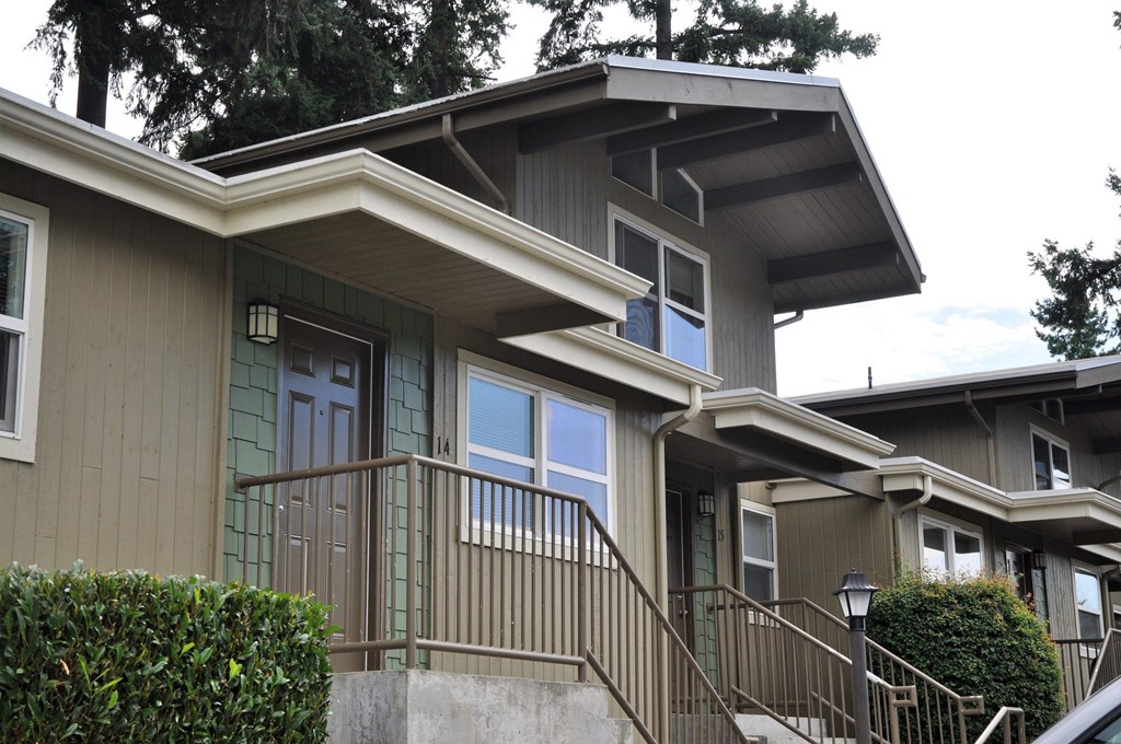 A house with a green door and a brown railing.