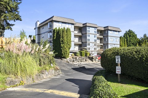 the view of an apartment building from the street