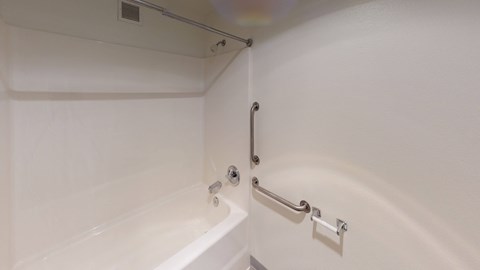a bathroom with a bath tub and a shower curtain