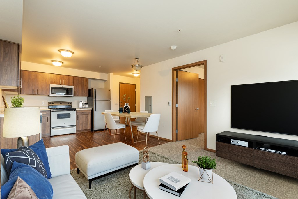 a living room with a couch and a table with a television