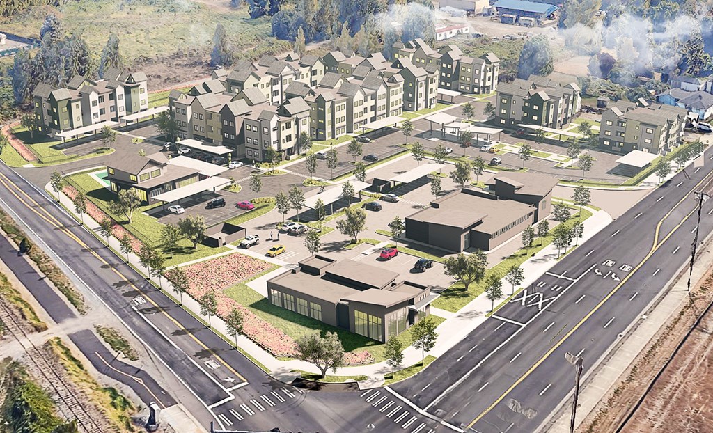 A street view of a residential area with houses and a road.