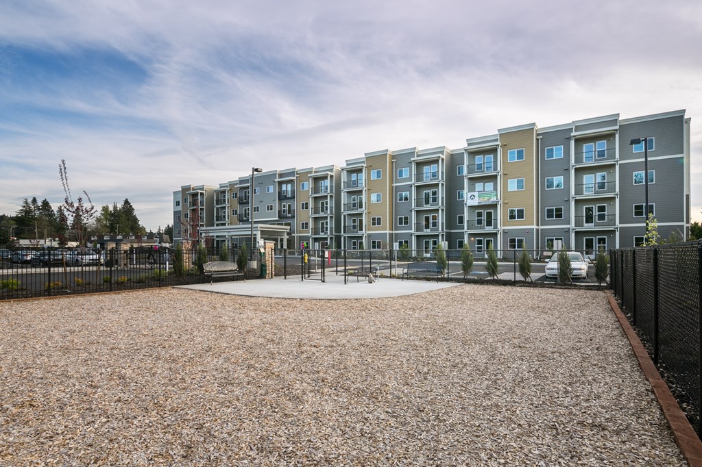 an empty playground in front of an apartment building