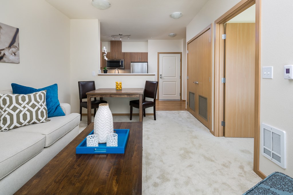 a living room and dining room with a couch and a table