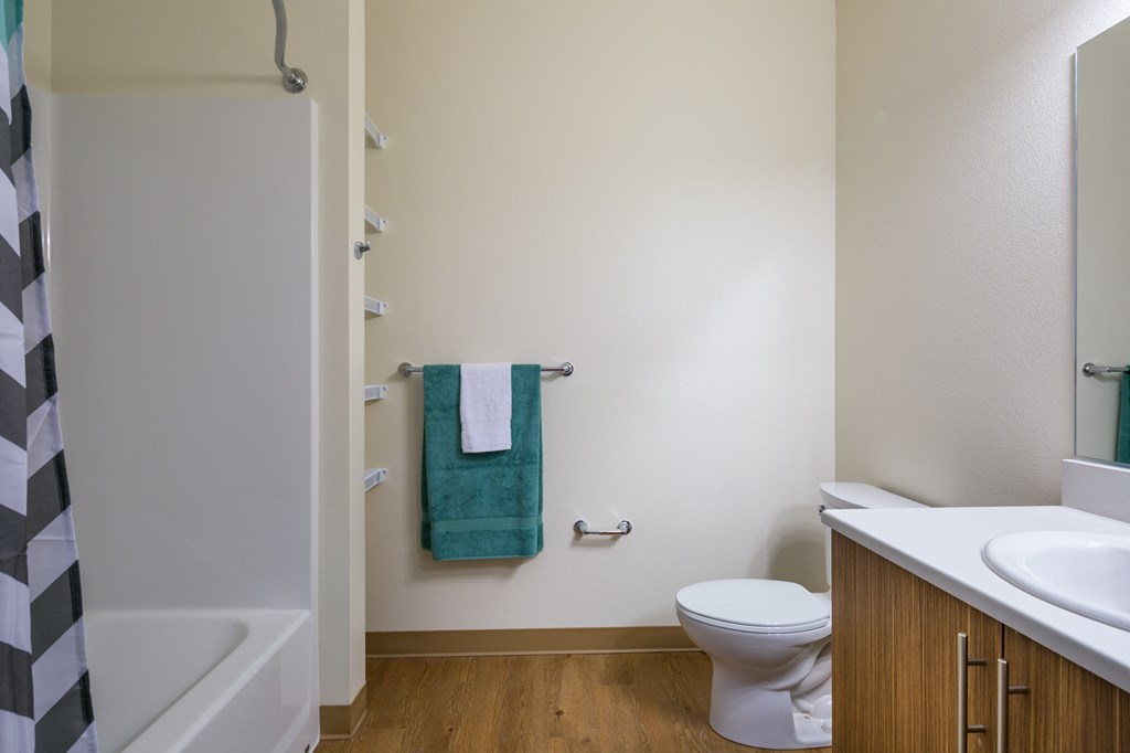 a bathroom with a toilet and a sink and a shower
