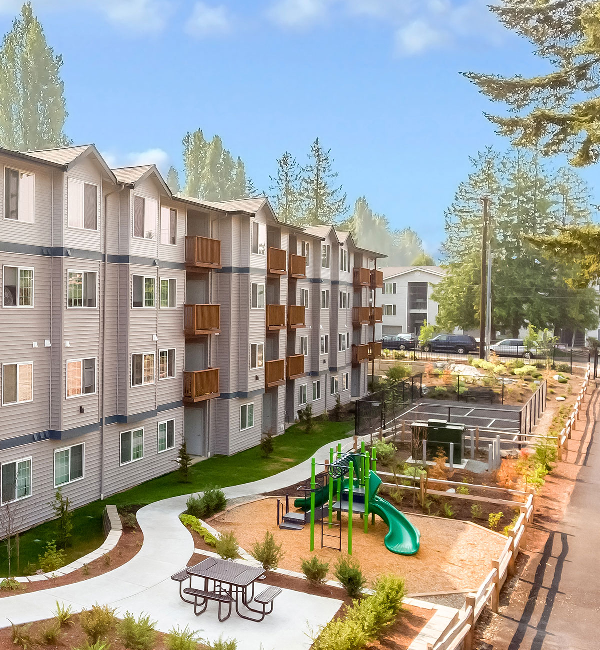 an exterior view of an apartment building with a childrens playground