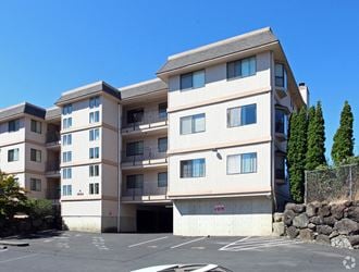 an empty parking lot in front of an apartment building