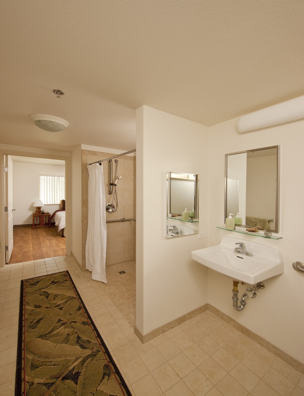 a bathroom with a sink and a mirror and a shower
