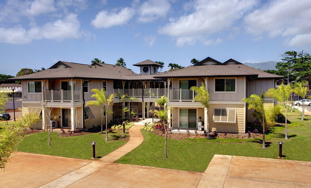 an aerial view of a house with a yard and a sidewalk