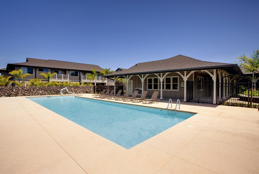 a swimming pool with a house in the background