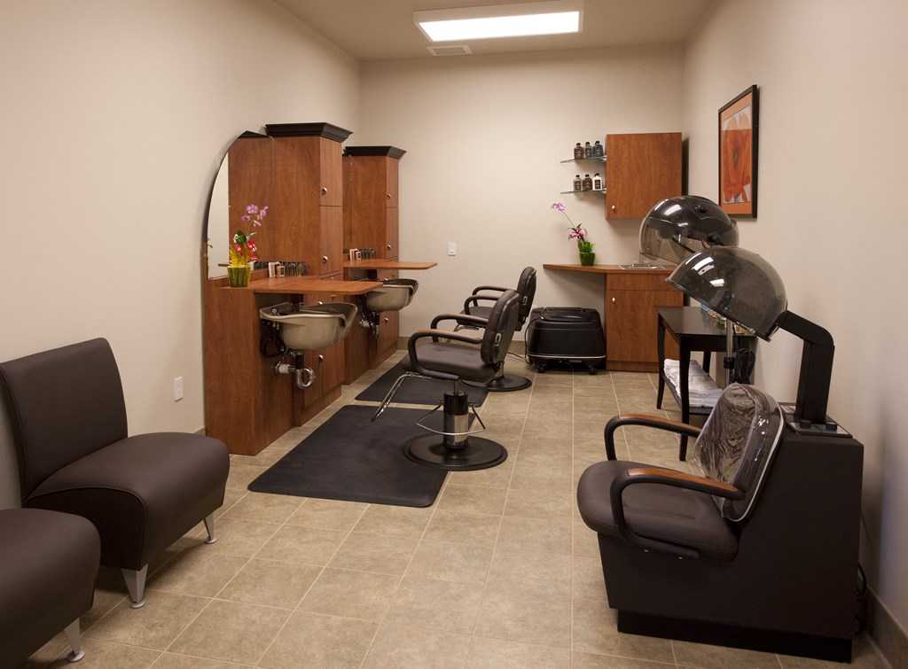 a salon room with chairs and a barber shop