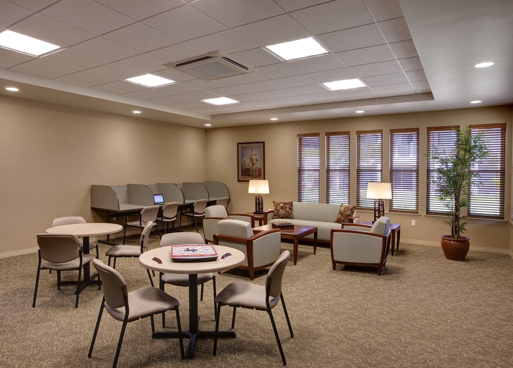 a conference room with tables and chairs and a projector screen