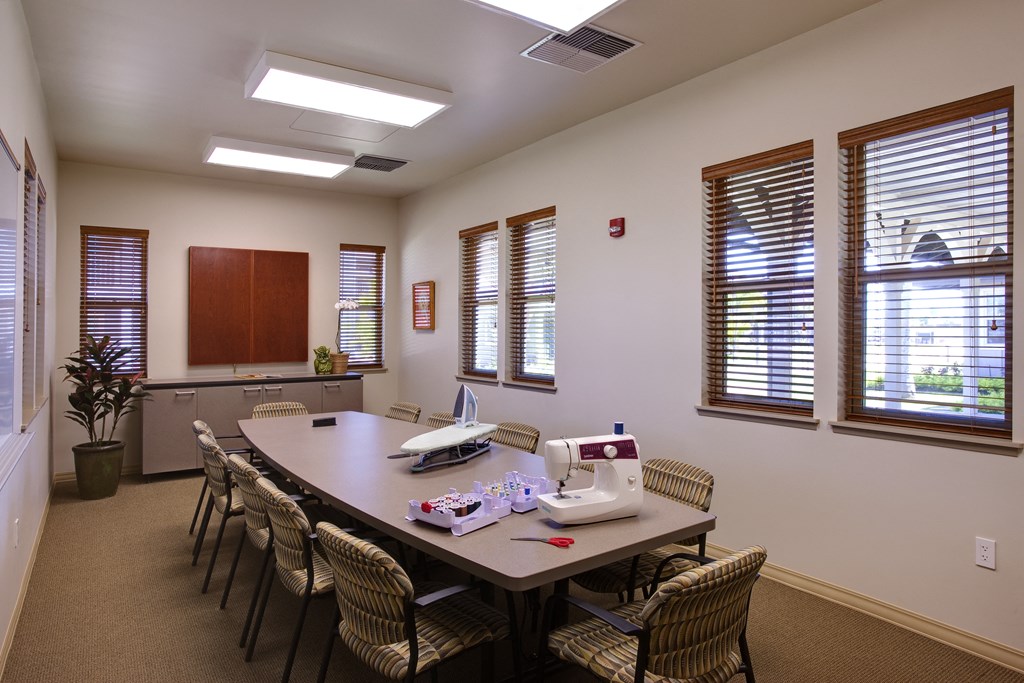 a conference room with a large table and chairs and windows