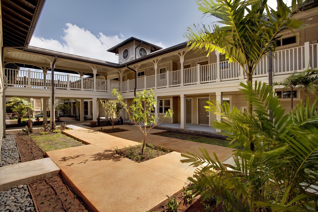 a building with a courtyard and palm trees
