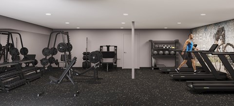 A woman is running on a treadmill in a gym with a variety of equipment.