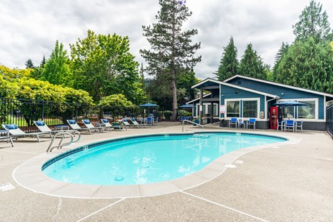 A pool with a blue sky and clouds in the background.